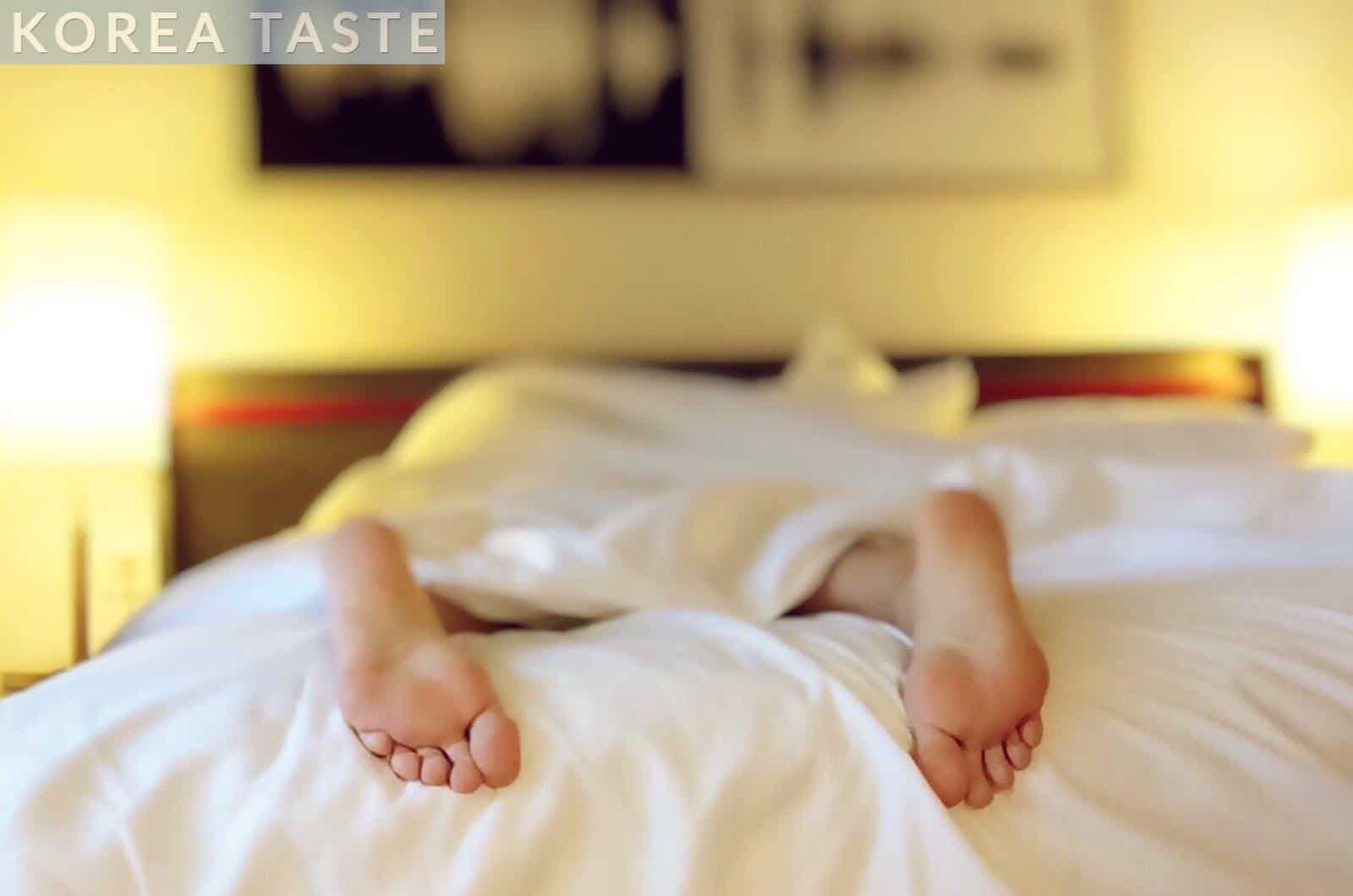 Person Lying on Bed Covering White Blanket