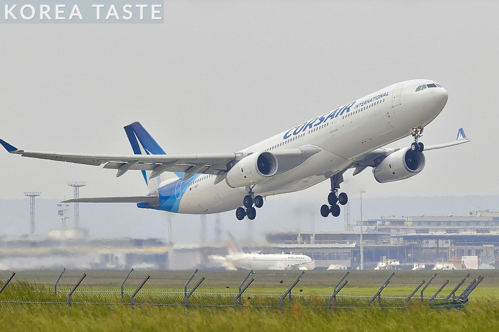 white and blue airplane about to fly at the airport